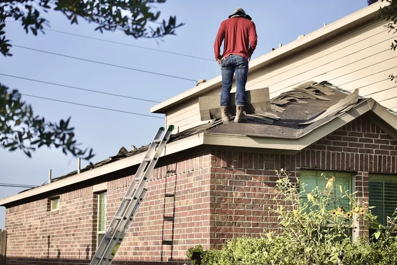 Professional roofer working on a residential roof in Metuchen
